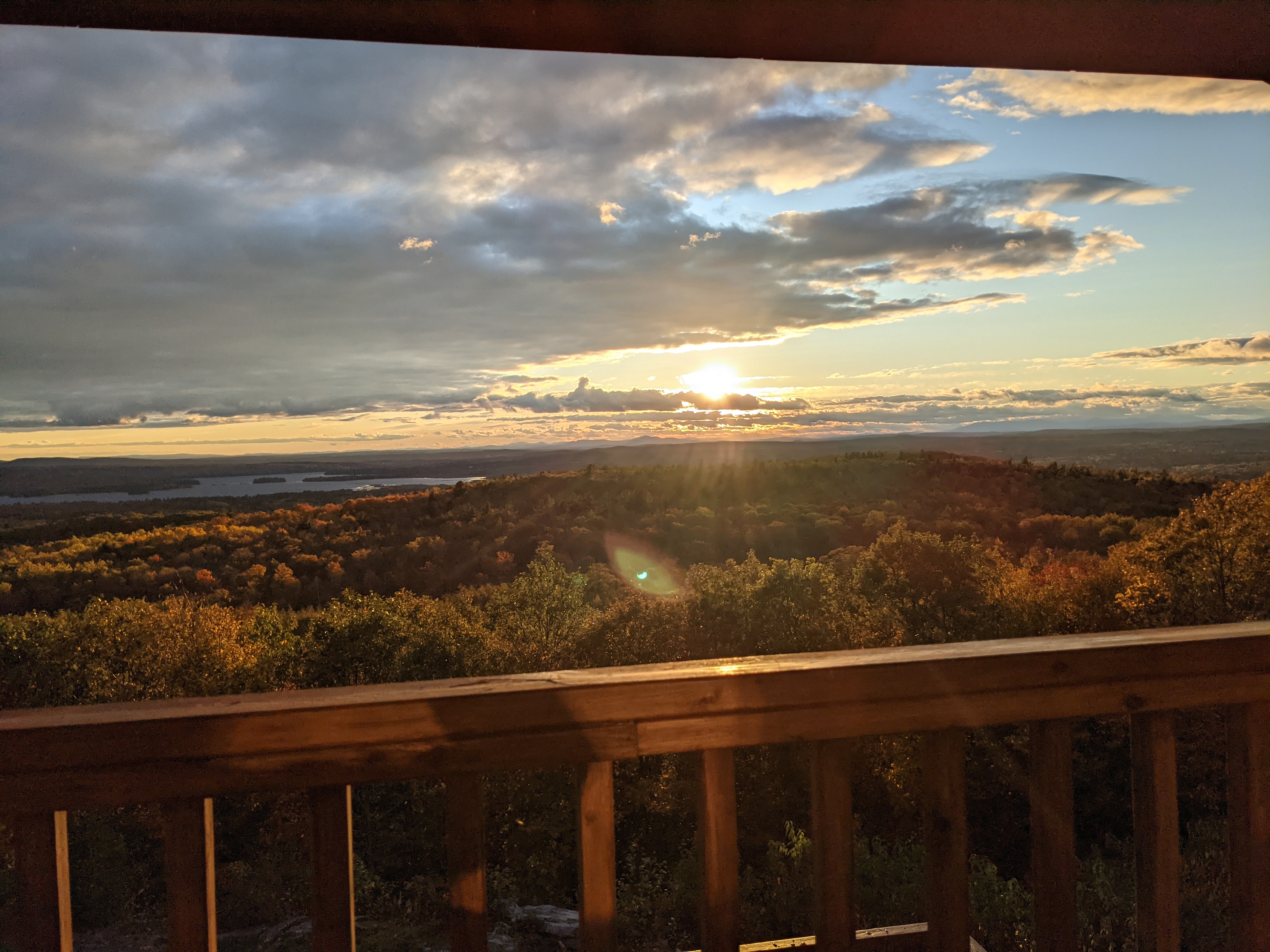 Peak fall foliage and sunset from the deck, with the lake in the distance